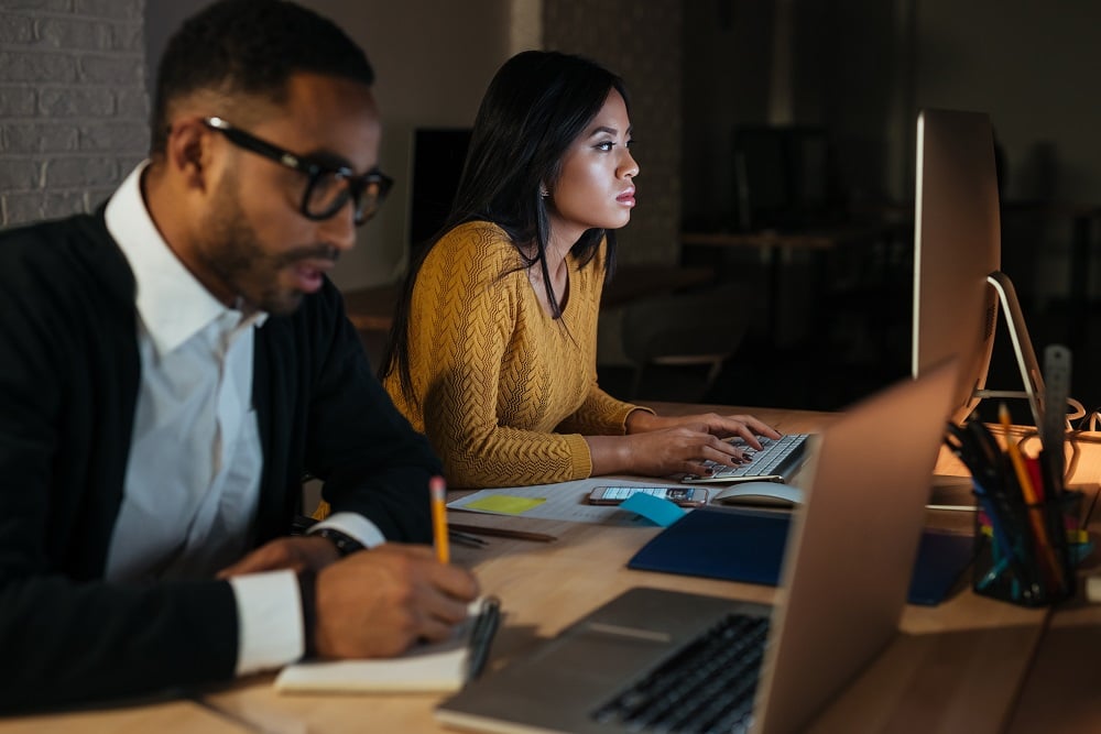 MAn and woman working on laptop