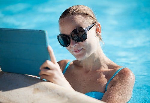 Woman on mobile device in a pool
