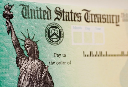 A blank US goverment check with selective focus on the statue of liberty