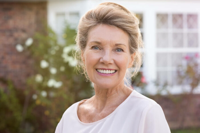 Senior woman outdoors and smiling